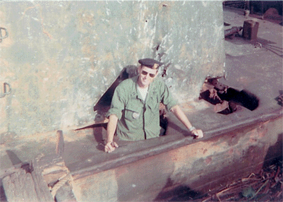 LT. Bell Standing in a severely damaged RAID boat.