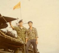 Standing on top of the cockswains flat with the boat captain of the HQ5116 boat. The mast in the background with the Vietnamese flag is the Benewah.